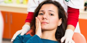 A woman with a toothache looks worried