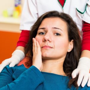 A woman with a toothache looks worried